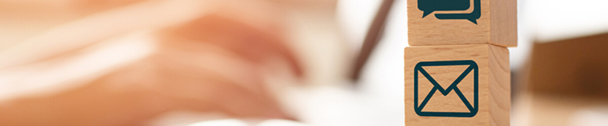 E-mail marketing concept, Hand using computer sending message with wooden cube block with icon mail address and telephone symbol